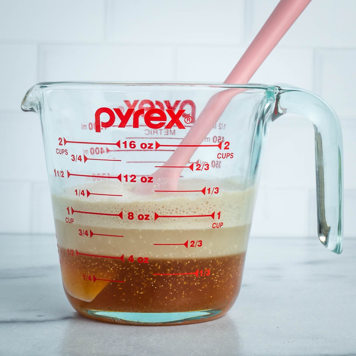 Side view of glass with yeast that's proofed.