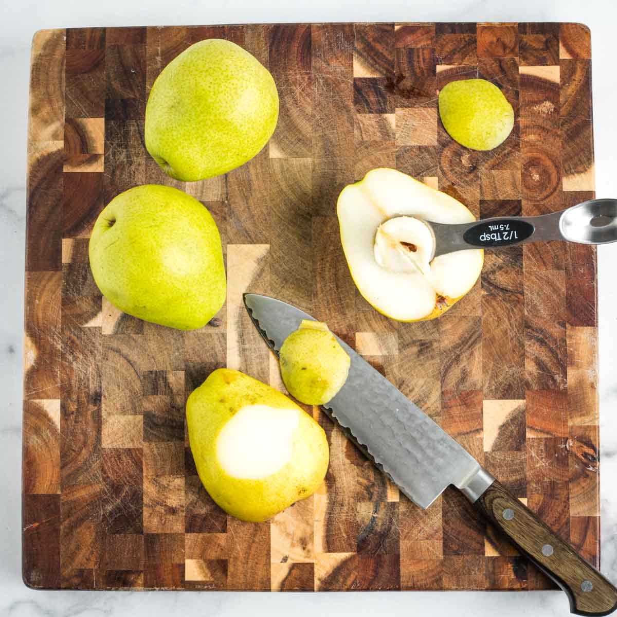 Pears, sliced through center, core scooped out, sliver cut off outside so halves can have stability. 