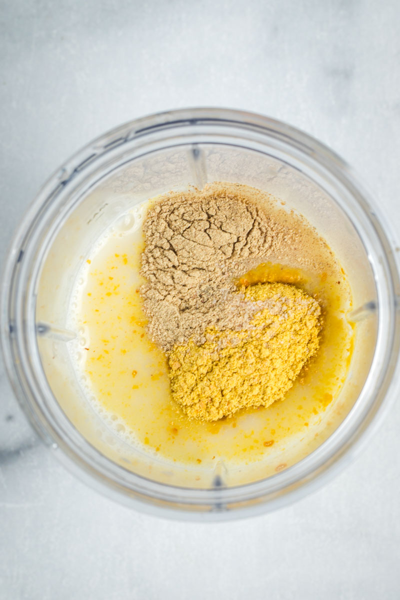 Milk, broth, nutritional yeast, salt and pepper in a blender cup. 