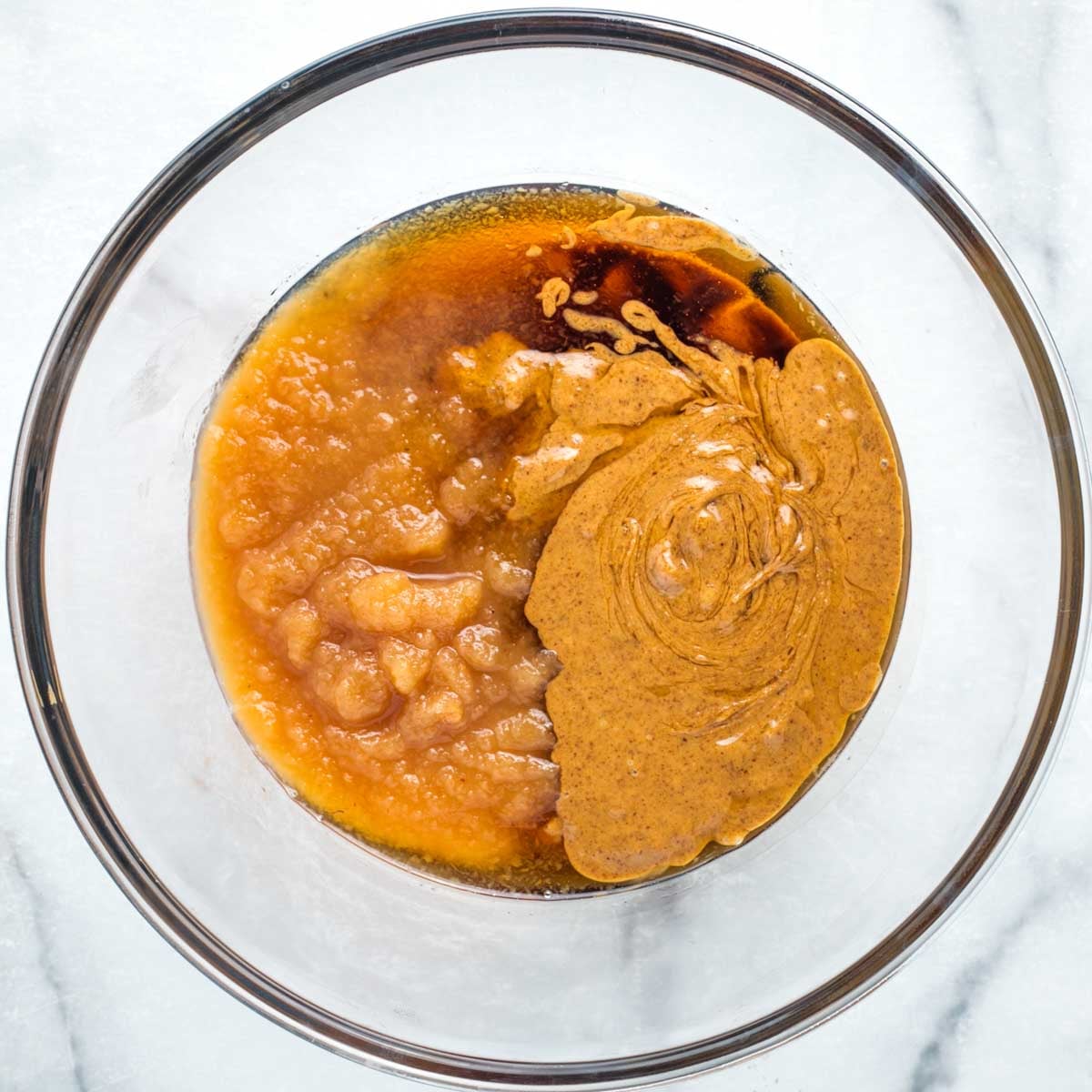ALmond butter, applesauce and maple syrup in a bowl.