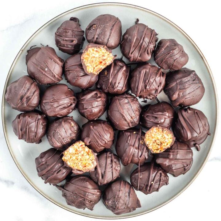 Plate of matzo crack balls dipped in chocolate and then drizzled with more chocolate.