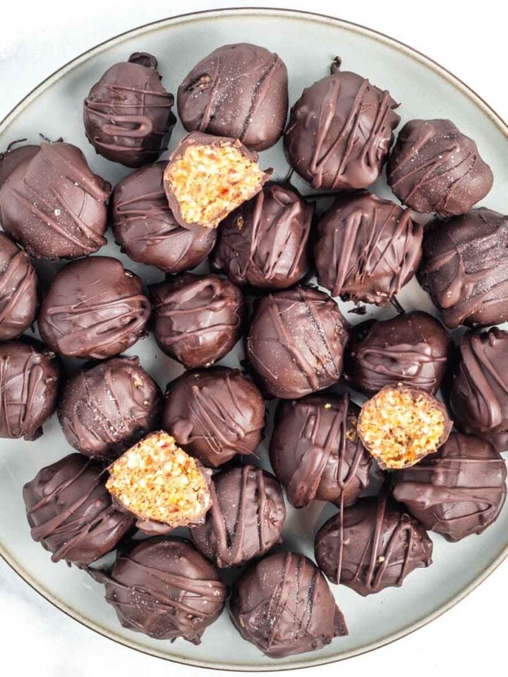 Plate of matzo crack balls dipped in chocolate and then drizzled with more chocolate.