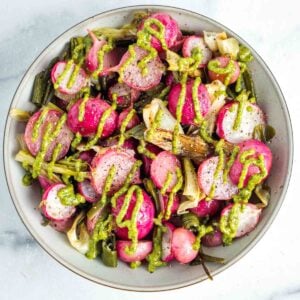 Roasted red radishes and scallions with a pistachio parsley drizzle.