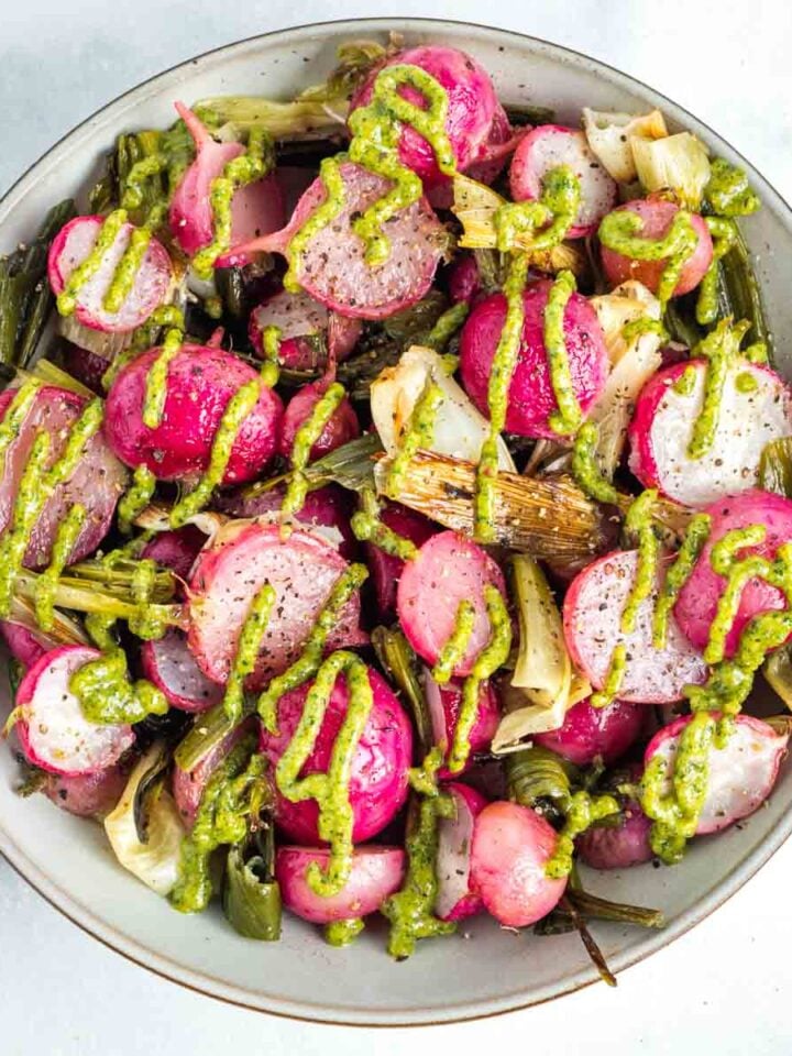Roasted red radishes and scallions with a pistachio parsley drizzle.