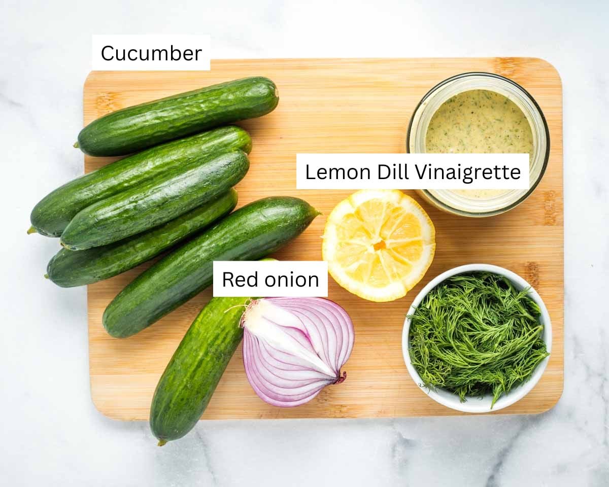 Cucumbers, half a red onion, half a lemon, small bowl of fresh dill and a small dish of lemon dill vinaigrette. 