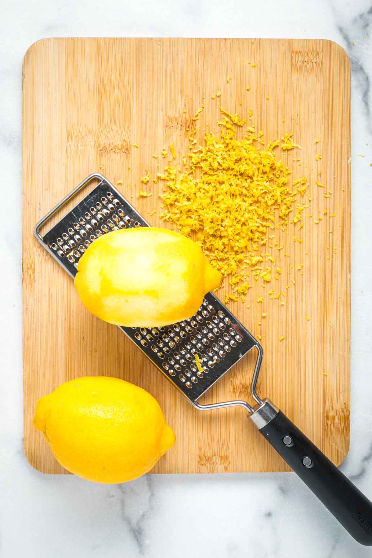 Microplane zester finely grating the lemon skin off. 