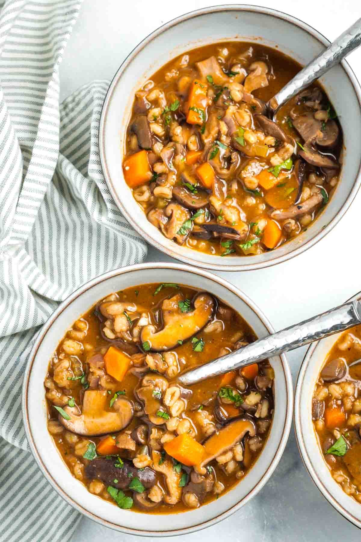 Bowls of chunky mushroom barley soup. 