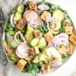 Bed of greens topped with slices of cucumber, shallot, avocado and crisp cubes of tofu drizzled with sesame ginger dressing.