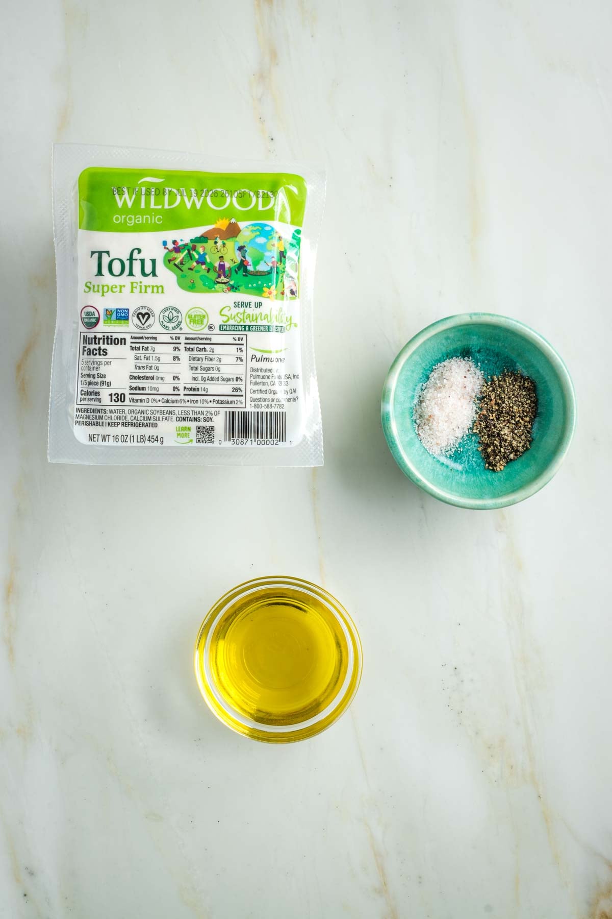 Block of tofu, small dish of olive oil, salt and pepper.