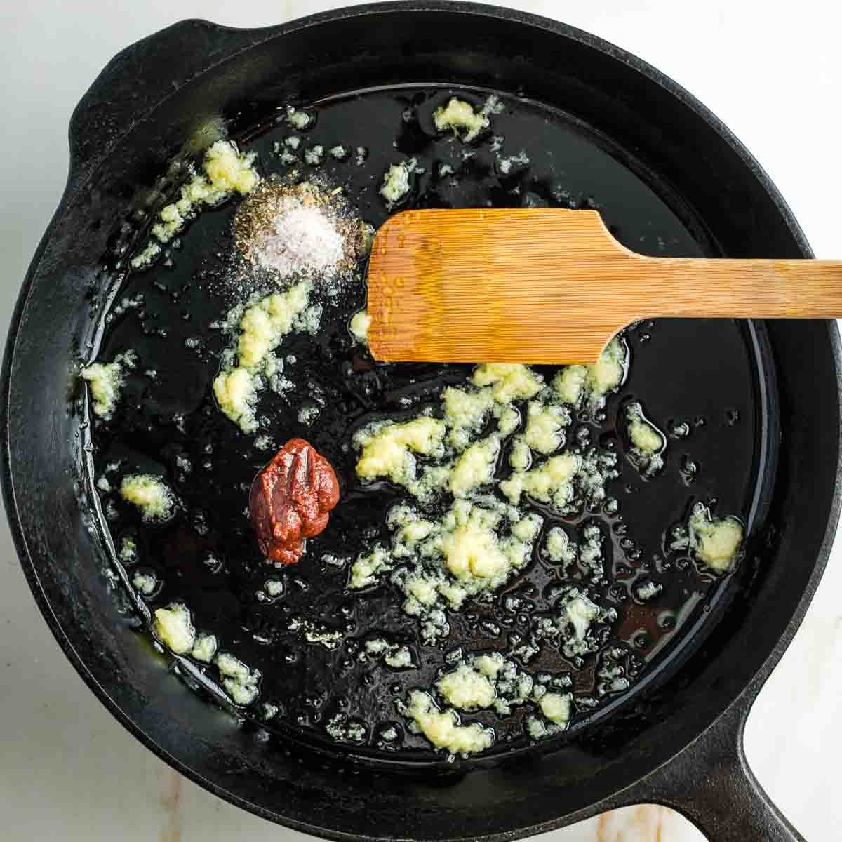 Sauteed garlic in a cast iron skillet with a tablespoon tomato paste plus seasonings. 
