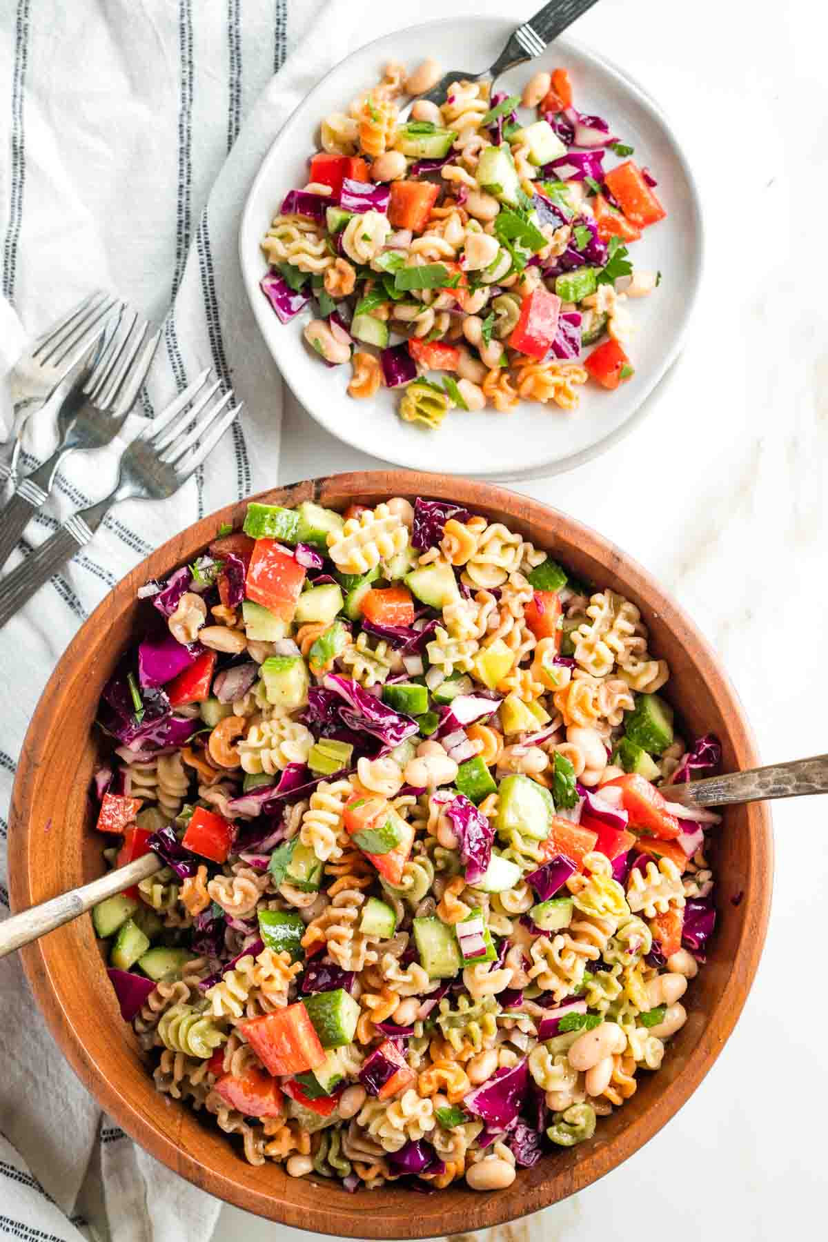 Tri-color pasta with cucumber, red pepper, purple cabbage, parsley, white beans pepperoncini and red onion. 
