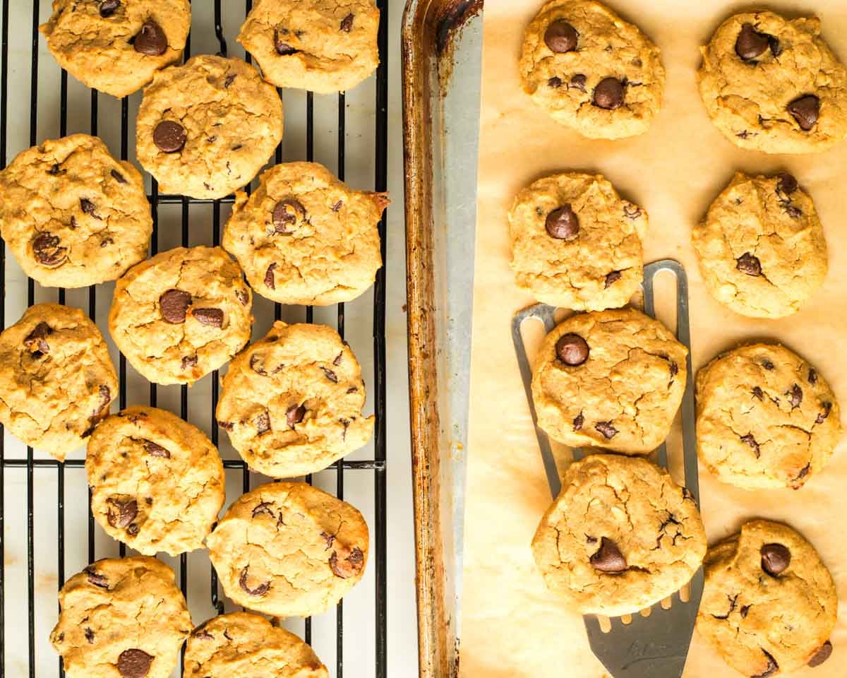 Transferring cookies from a baking tray to a wire cooling rack.