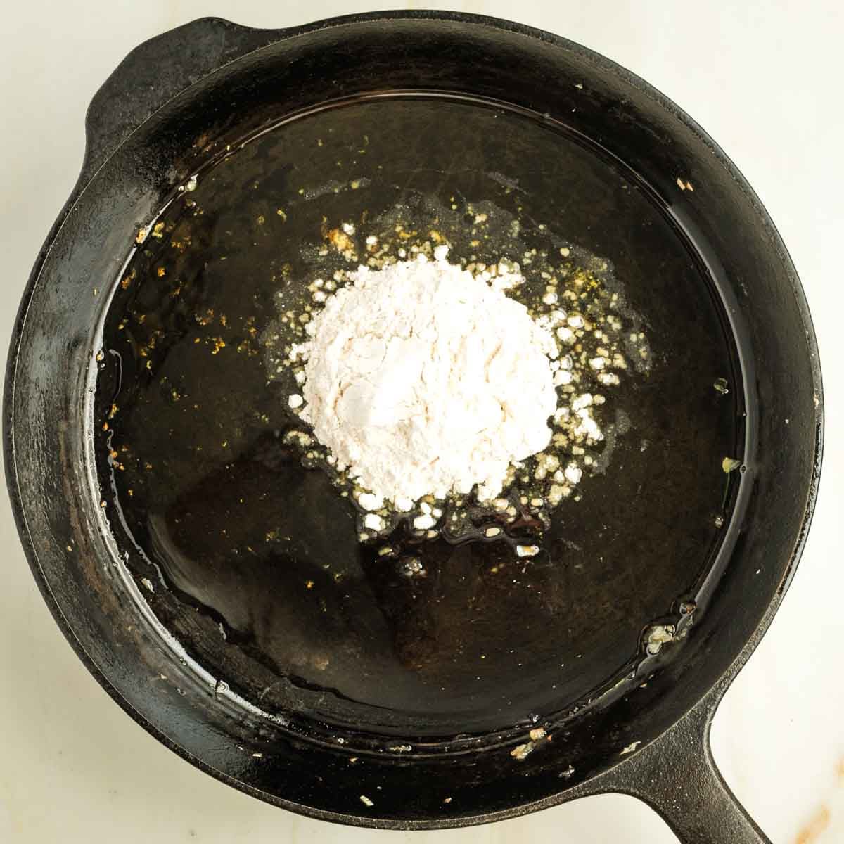 Cast iron skillet with oil and flour.