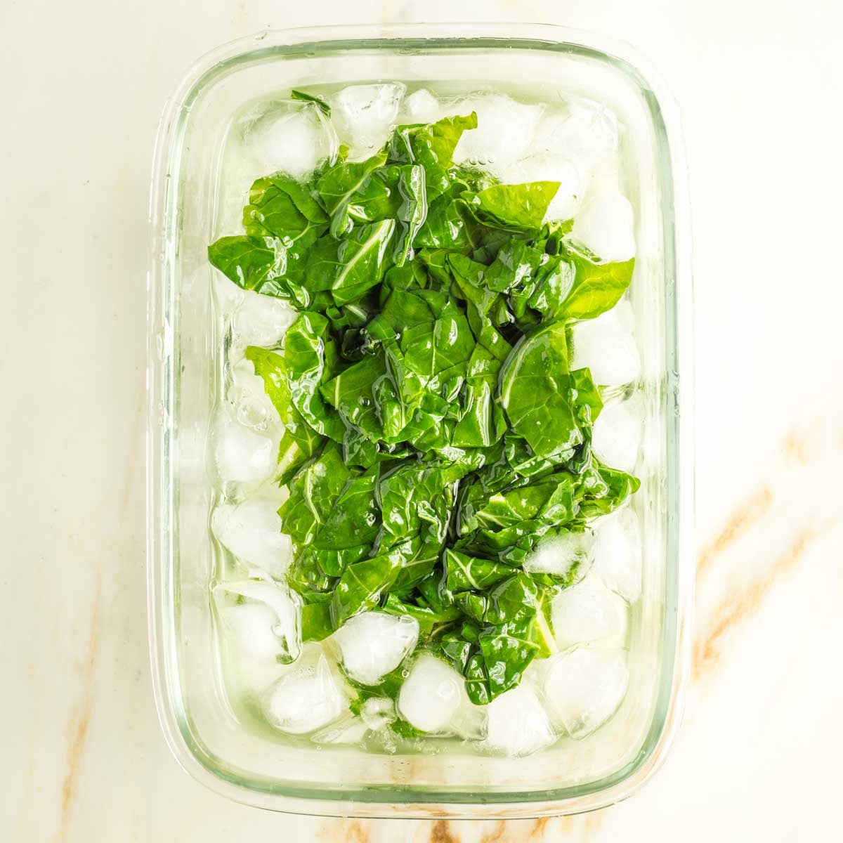 Lightly cooked chard leaves in an ice bath. 