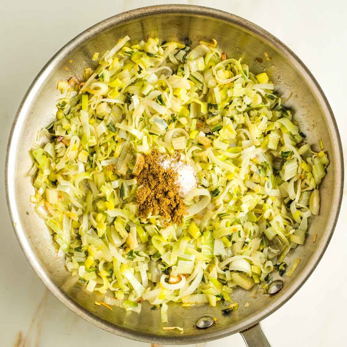 Sauteed leeks and chard stems sprinkled with cumin and salt.
