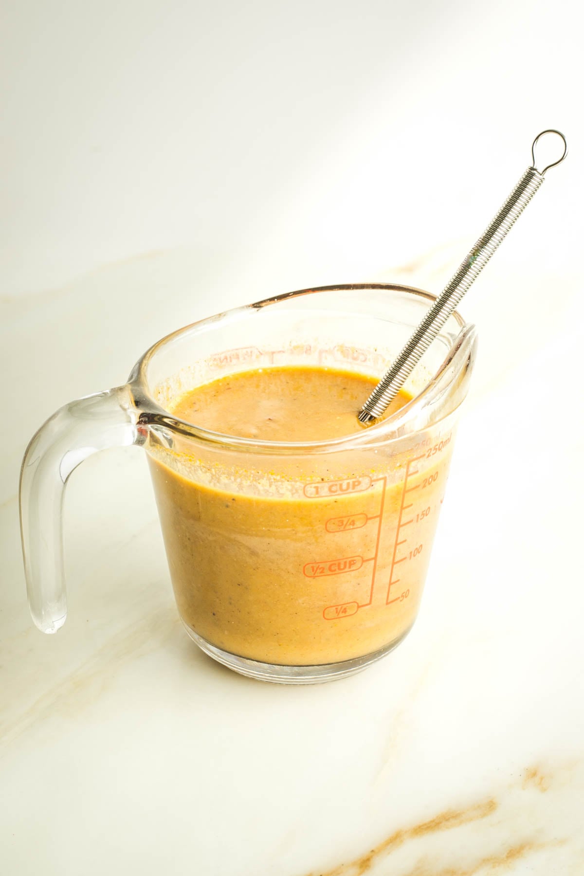 Whisked maple tahini sauce for leek and swiss chard patties. 