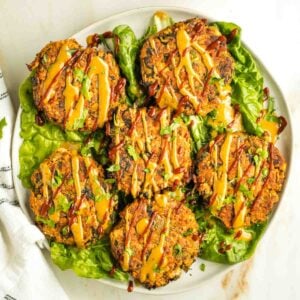 Leek patties on a bed of swiss chard, drizzled with tahini sauce and sriracha.