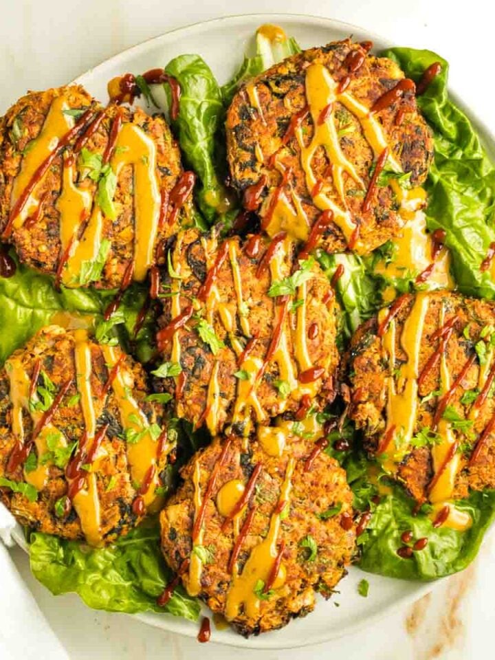 Leek patties on a bed of swiss chard, drizzled with tahini sauce and sriracha.
