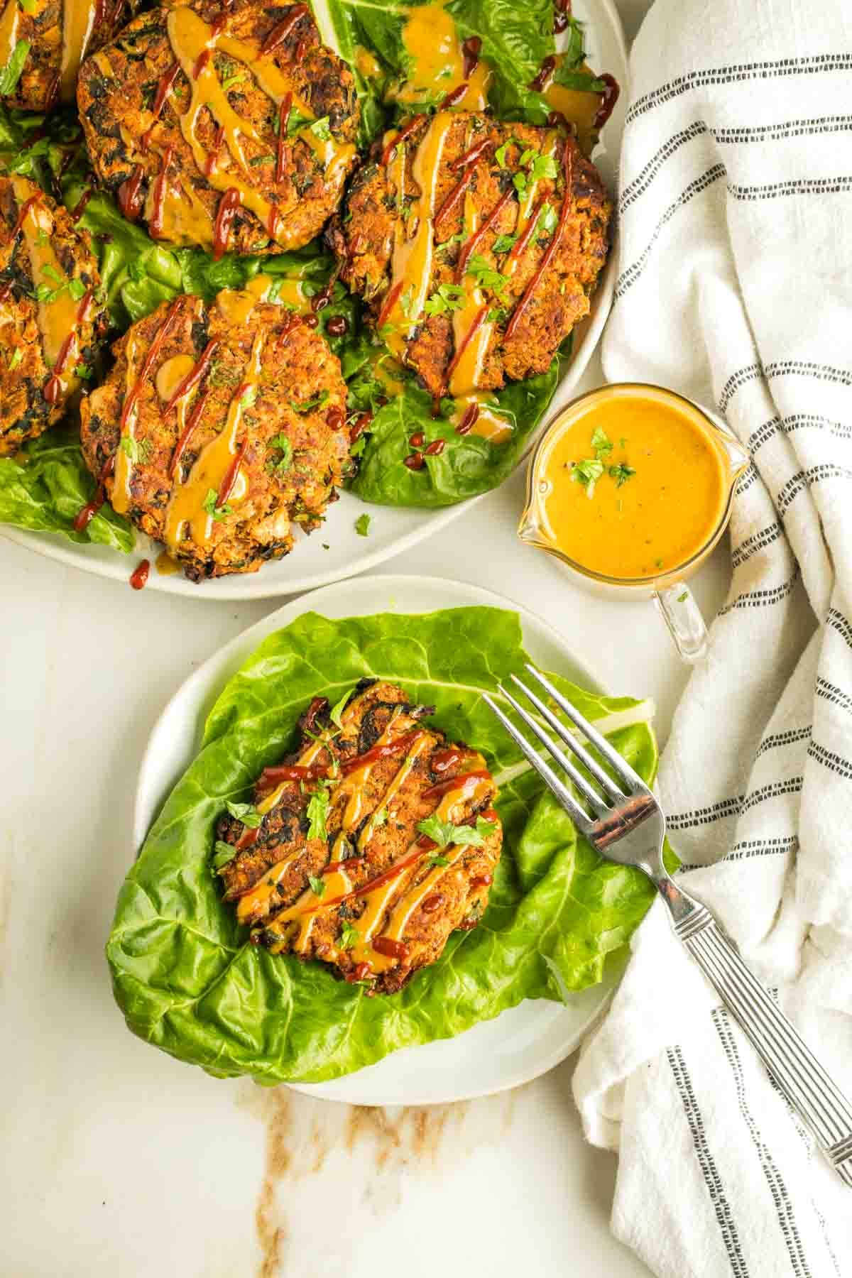 Leek patties on a bed of swiss chard, with a tahini sauce and sriracha drizzle.