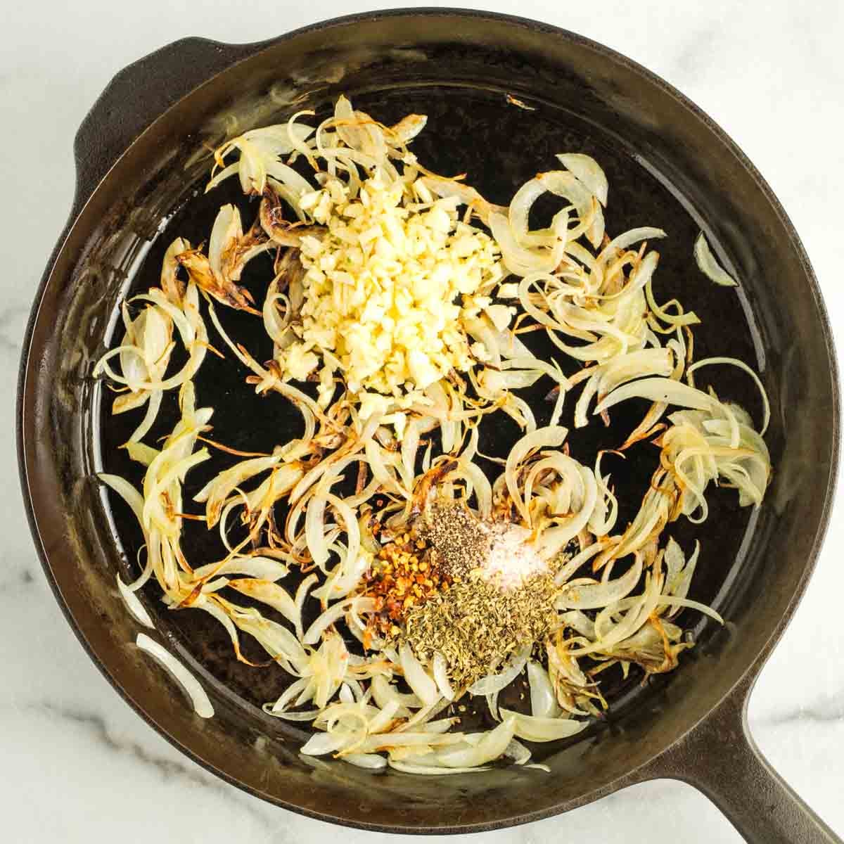 Caramelized thin slices of onion with chopped garlic and spices.