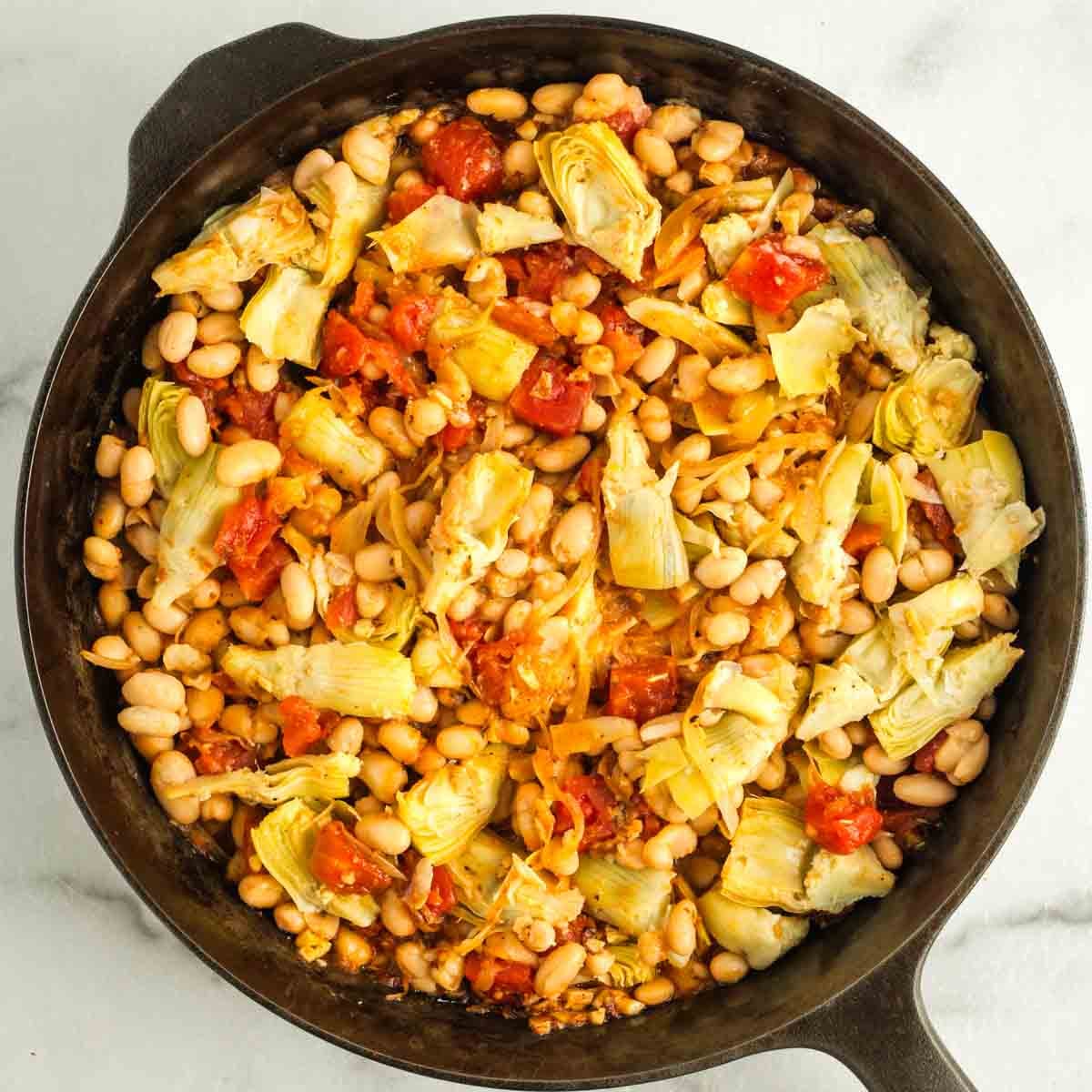 Artichoke heart, tomato, onion and bean skillet meal.