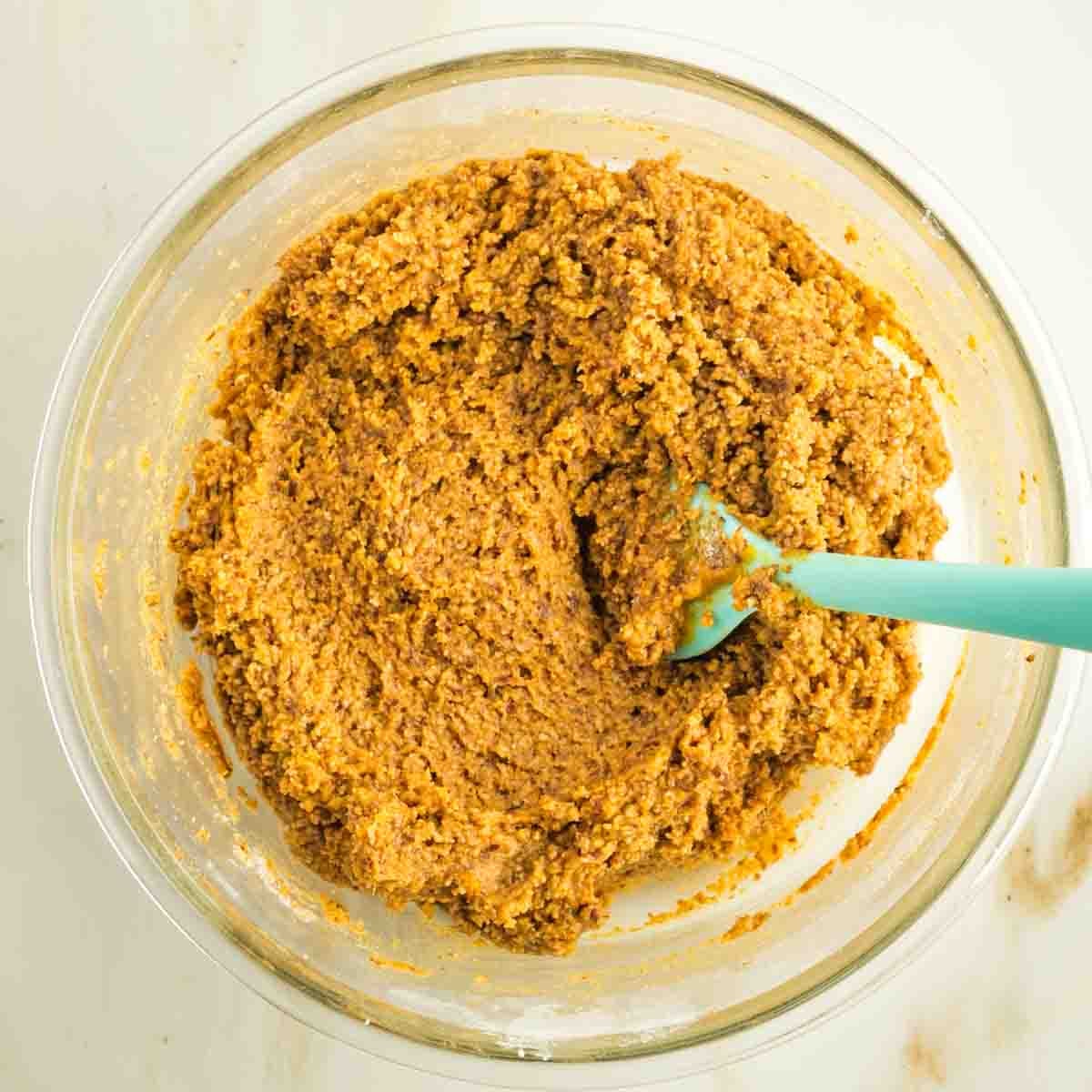 Pumpkin cookie batter, mixed in a glass bowl. 